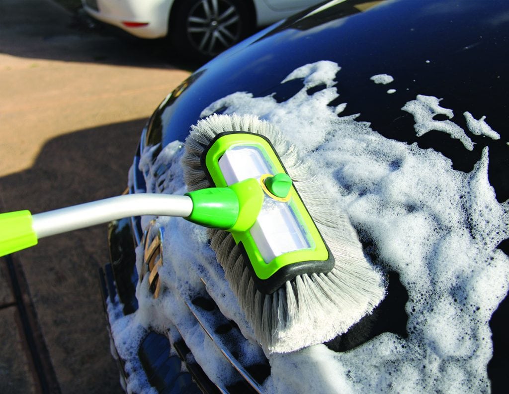 Woman using premium car wash brush